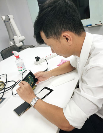 製品の修理をベトナム人スタッフにレクチャー